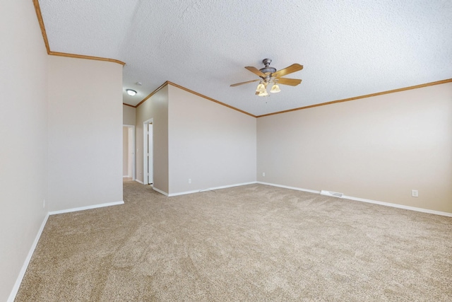 spare room featuring baseboards, a ceiling fan, ornamental molding, a textured ceiling, and carpet flooring