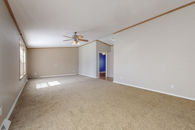 carpeted spare room featuring a textured ceiling, baseboards, a ceiling fan, and crown molding