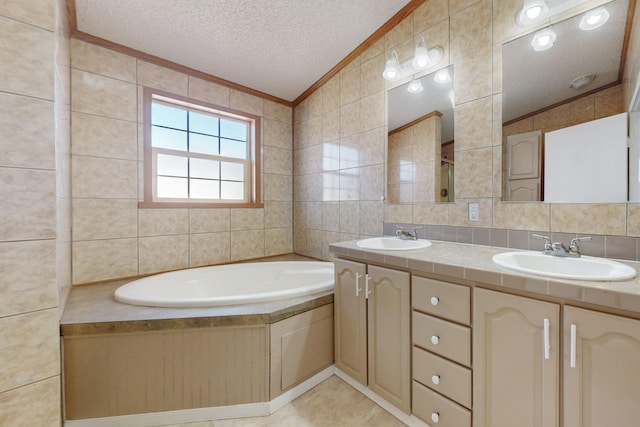 full bathroom with a textured ceiling, ornamental molding, a sink, and tile walls