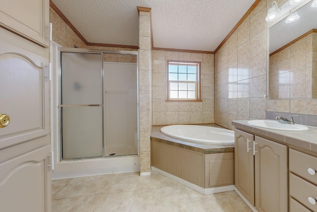 full bathroom with a textured ceiling, a shower stall, tile walls, and crown molding