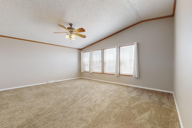 empty room featuring lofted ceiling, visible vents, ornamental molding, and a textured ceiling