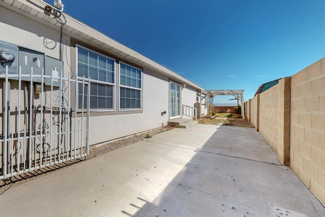 view of property exterior featuring a patio area and a fenced backyard