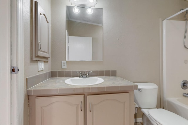 bathroom featuring toilet, shower / bathing tub combination, and vanity