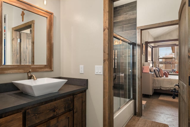 bathroom with enclosed tub / shower combo, connected bathroom, concrete floors, vanity, and vaulted ceiling