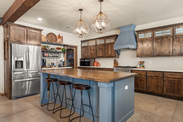 1800 Los Pinos Rd, Bosque Farms, NM 87068 - kitchen featuring appliances with stainless steel finishes, wooden counters, premium range hood, open shelves, and a chandelier