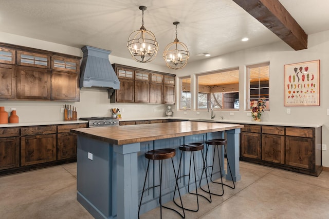 1800 Los Pinos Rd, Bosque Farms, NM 87068 - kitchen featuring butcher block countertops, premium range hood, a chandelier, a kitchen island, and a breakfast bar