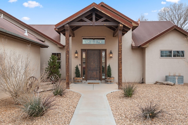 1800 Los Pinos Rd, Bosque Farms, NM 87068 - doorway to property with stucco siding and metal roof