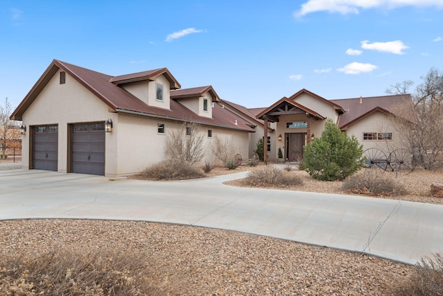 1800 Los Pinos Rd, Bosque Farms, NM 87068 - view of front of home with concrete driveway, stucco siding, a garage, and metal roof