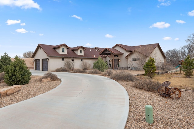 1800 Los Pinos Rd, Bosque Farms, NM 87068 - view of front facade with stucco siding, curved driveway, and a garage