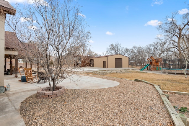 1800 Los Pinos Rd, Bosque Farms, NM 87068 - view of yard with a playground, an outbuilding, a patio, and a garage