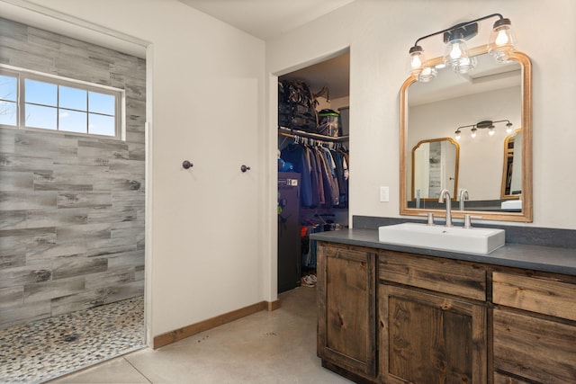 1800 Los Pinos Rd, Bosque Farms, NM 87068 - full bathroom featuring vanity, tiled shower, baseboards, and a spacious closet