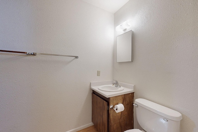 bathroom with toilet and vanity