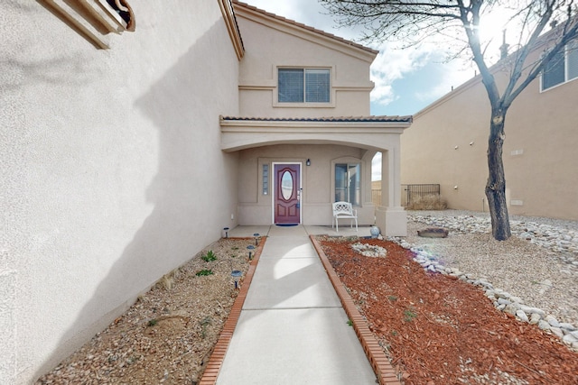 entrance to property with stucco siding