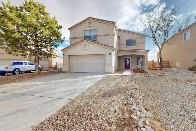 view of front of property featuring a garage, fence, concrete driveway, a tiled roof, and stucco siding