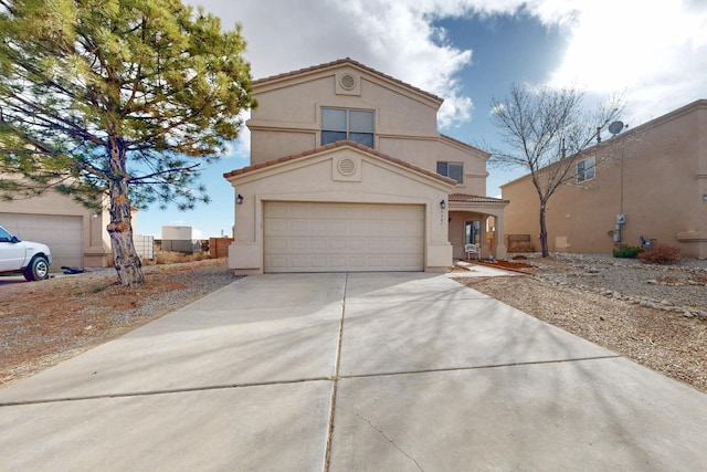 view of front of home featuring concrete driveway, a tile roof, and stucco siding