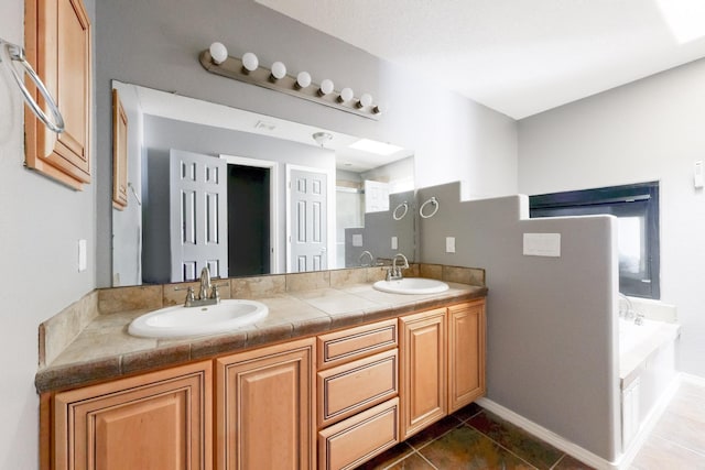 bathroom with walk in shower, a garden tub, a sink, and double vanity