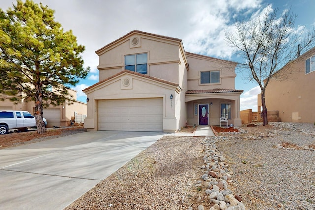 mediterranean / spanish-style home with a garage, concrete driveway, a tiled roof, fence, and stucco siding