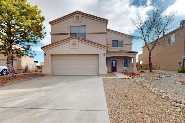 mediterranean / spanish home with driveway, a tiled roof, a garage, and stucco siding