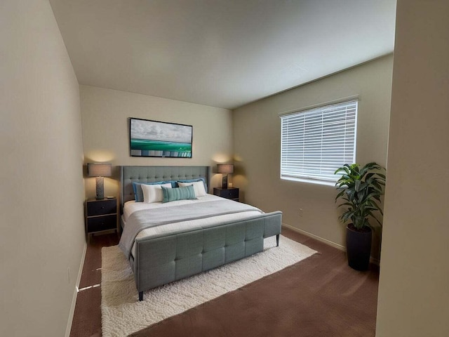 bedroom featuring carpet floors and baseboards