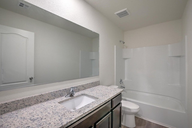 full bathroom with toilet, bathing tub / shower combination, vanity, and visible vents