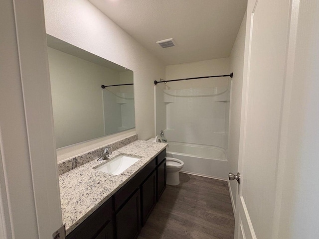 bathroom with toilet, shower / bath combination, wood finished floors, visible vents, and vanity