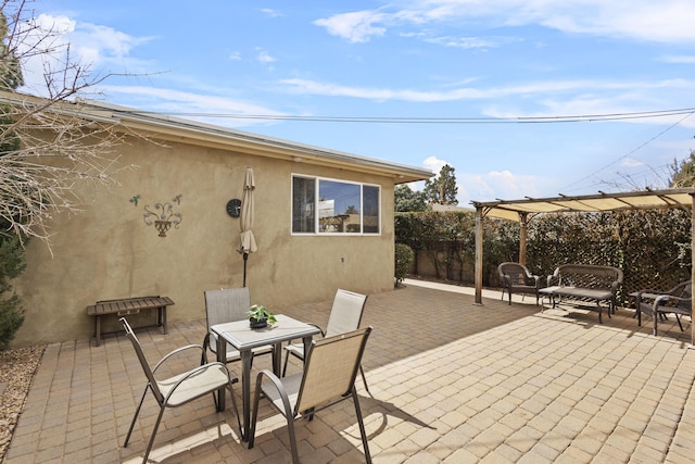 view of patio with outdoor dining area, fence, and a pergola