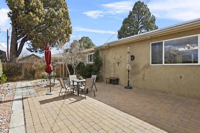 view of patio with fence and outdoor dining space