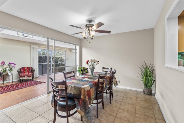 dining space featuring a wall mounted air conditioner, baseboards, a ceiling fan, and light tile patterned flooring