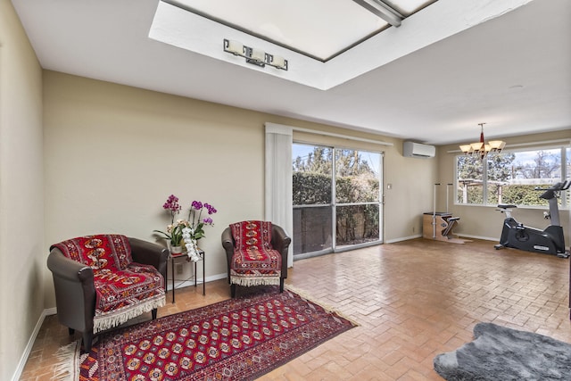 sitting room featuring brick floor, baseboards, and a wall mounted air conditioner