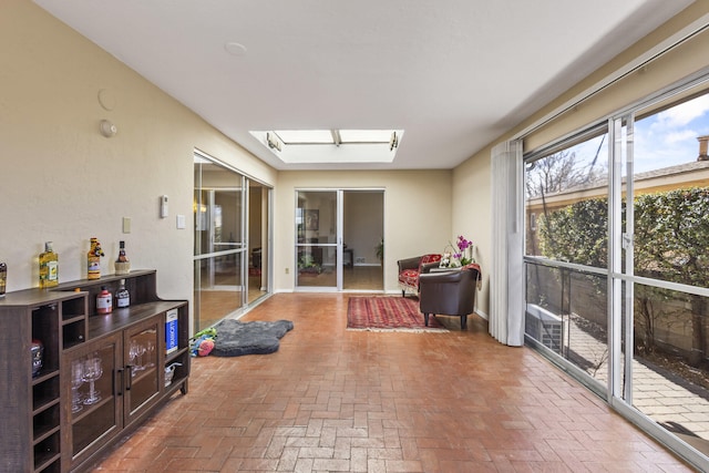 sunroom / solarium featuring a skylight