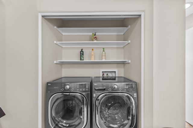 washroom with a bar, laundry area, and washer and clothes dryer