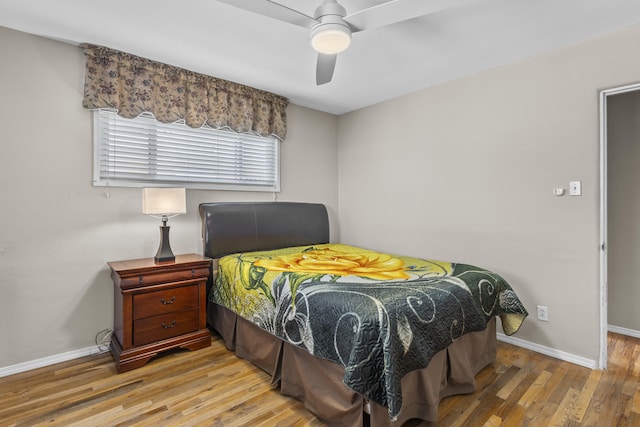 bedroom featuring wood finished floors, a ceiling fan, and baseboards