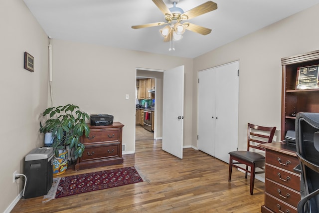 office featuring ceiling fan, wood finished floors, and baseboards