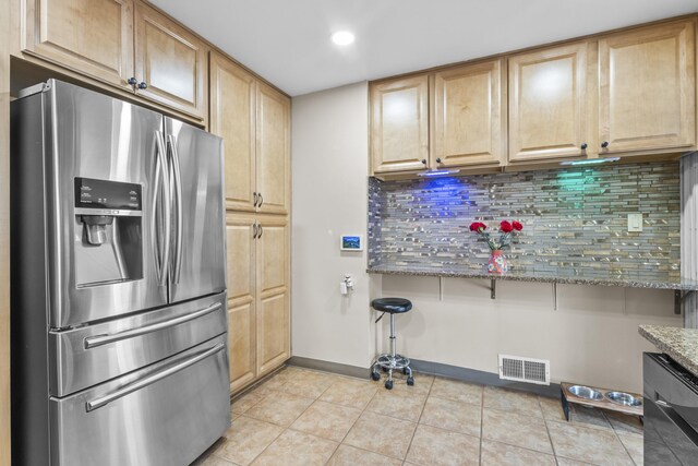 kitchen with light tile patterned floors, visible vents, appliances with stainless steel finishes, backsplash, and light stone countertops