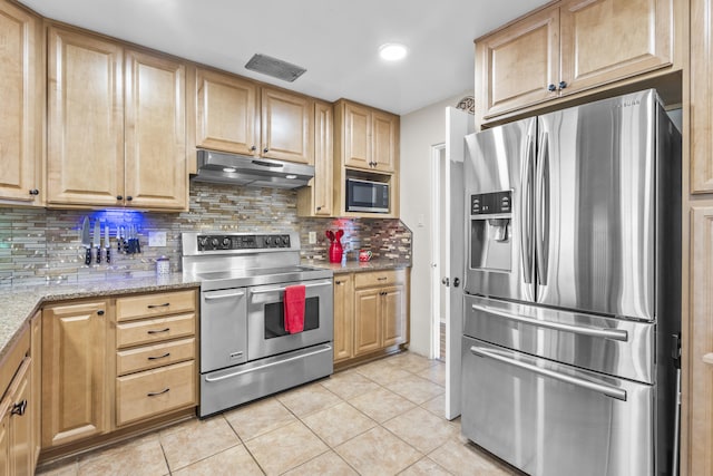 kitchen featuring under cabinet range hood, visible vents, light tile patterned floors, and appliances with stainless steel finishes