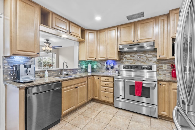 kitchen with light tile patterned floors, stainless steel appliances, visible vents, a sink, and under cabinet range hood