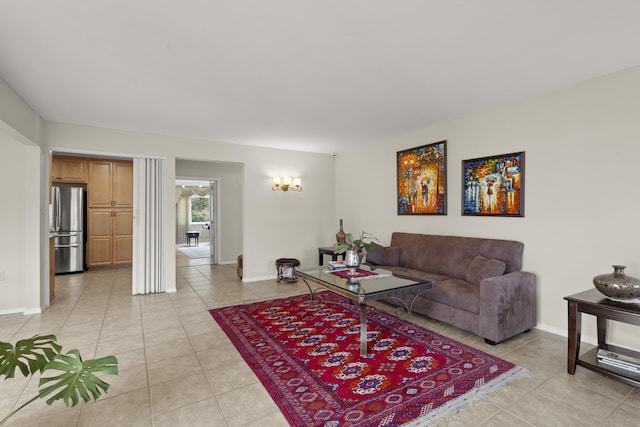 living area featuring light tile patterned floors and baseboards