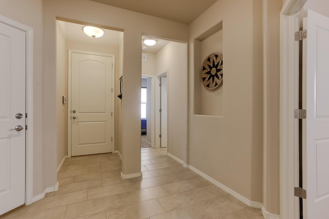 hallway with visible vents and baseboards