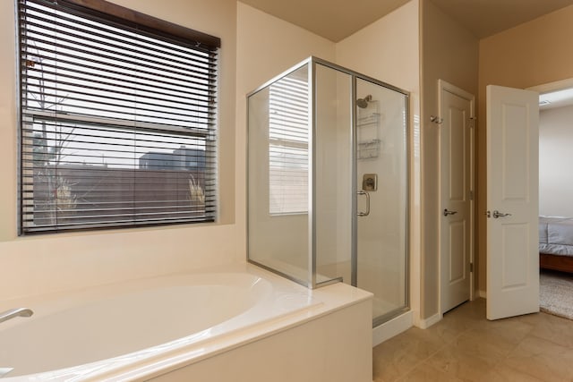 bathroom with ensuite bathroom, a stall shower, and a bath