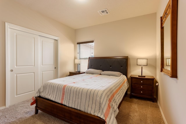 bedroom with carpet, a closet, visible vents, and baseboards