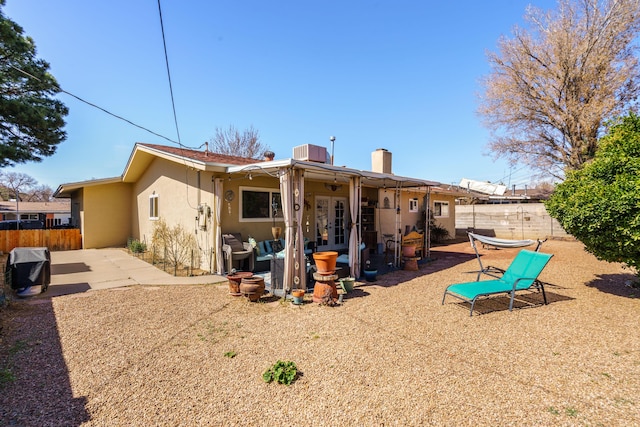 back of property with a patio area, a fenced backyard, french doors, and stucco siding