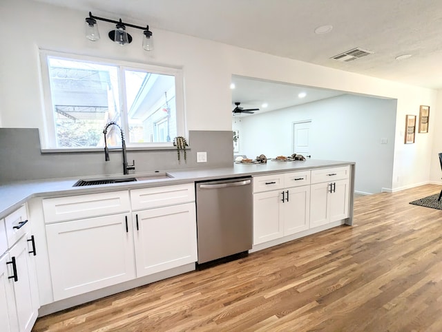 kitchen featuring a sink, visible vents, light wood-type flooring, and dishwasher