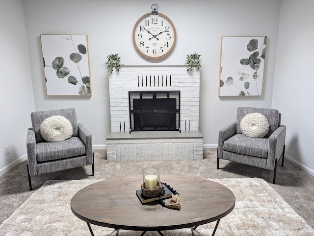 living area featuring baseboards, carpet floors, and a fireplace