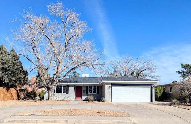 ranch-style home with driveway, a garage, and fence