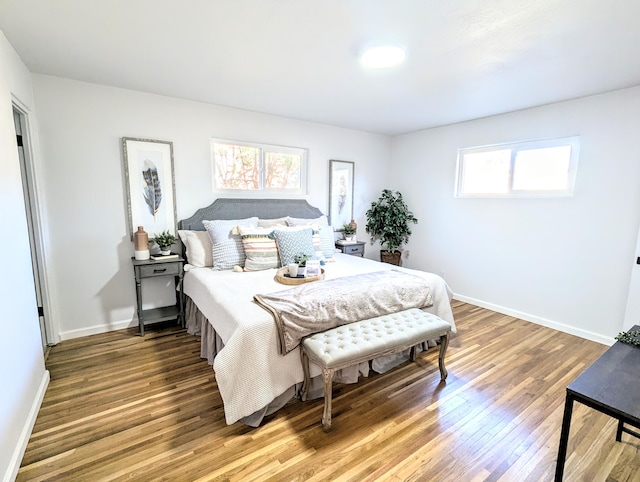 bedroom with baseboards and wood finished floors