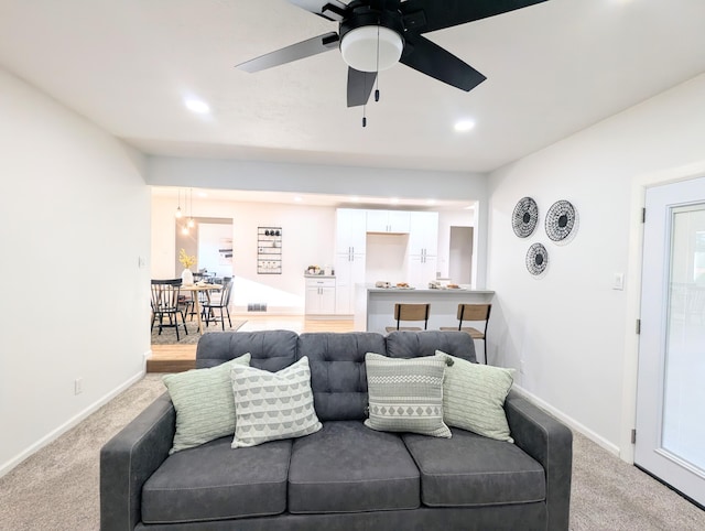 living area featuring recessed lighting, baseboards, ceiling fan, and carpet flooring