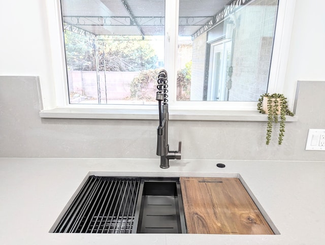 details featuring a sink and light countertops