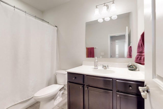 full bath with curtained shower, toilet, and vanity