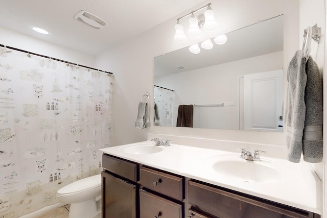 full bath with double vanity, toilet, visible vents, and a sink