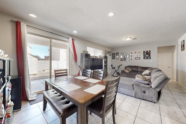 dining room featuring recessed lighting, a textured ceiling, and light tile patterned flooring